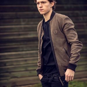 Tom Holland wearing brown cotton jacket on black ripped cuffs